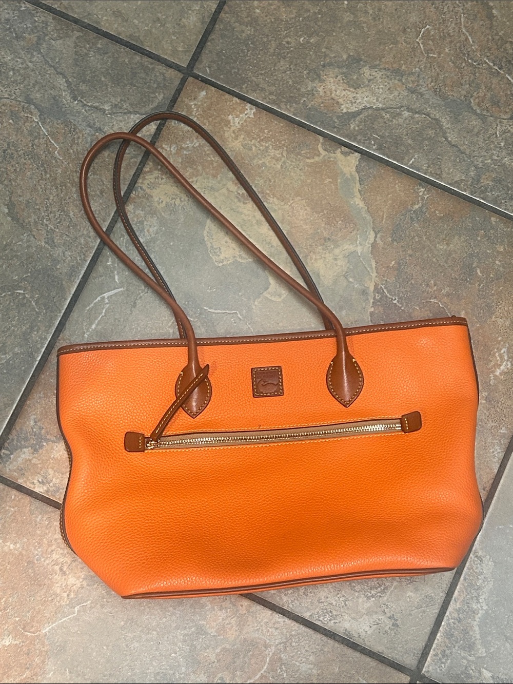 Dooney and Bourke Orange Leather Tote Bag with Brown Trim.